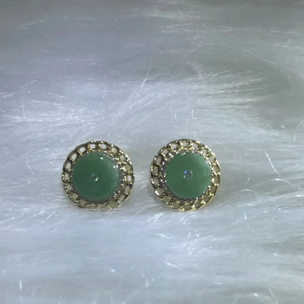 Elegant green jade stud earrings encircled by delicate gold patterns, combining classic beauty with contemporary style.