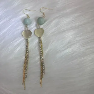 Elegant long earrings featuring jade round beads and delicate golden strands, culminating in a romantic heart charm.