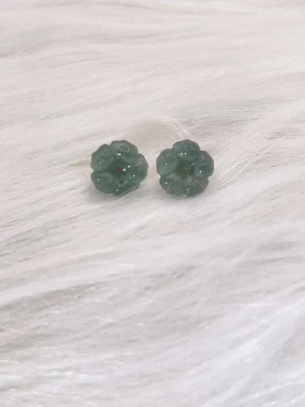 Elegant carved jade flower earrings symbolizing 'Blooming Wealth,' paired with the timeless beauty of jade for a luxurious finish.