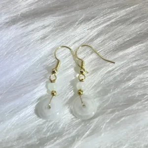 Elegant 'White Jade Safety Buckle Earrings,' with the serene beauty of white jade paired with delicate golden accents, offering a sophisticated accessory that carries deep cultural significance.