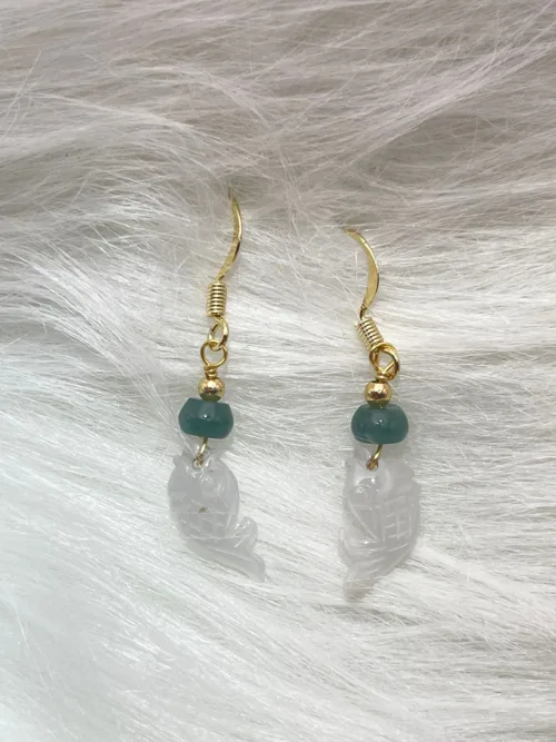 Jade fish-shaped earrings with green beads and golden accents, symbolizing 'Abundance Year After Year' for everlasting prosperity.