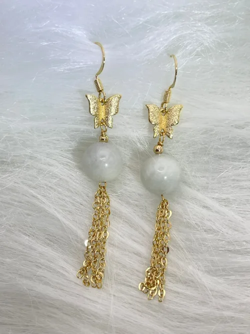 Elegant earrings featuring white jade orbs and golden butterflies, with flowing tassel chains, capturing the ethereal grace of 'White Jade Matching Pearls'.