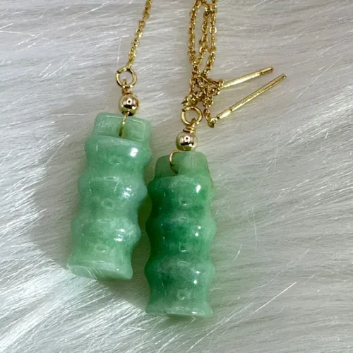 Green jade earrings carved in bamboo motifs, 'Bamboo Brings Safety', paired with 14K gold for lasting serenity.