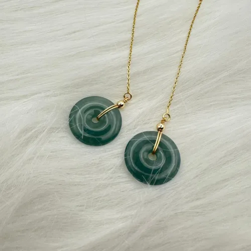 Green jade 'Peace Year After Year' circular earrings with a central 14K gold bar, symbolizing enduring tranquility.