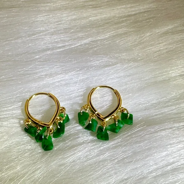 Gold hoop earrings with dangling jade stones from the 'Rising Step by Step' collection, symbolizing career and personal growth.