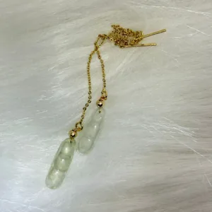 Elegant jade 'Achieving Triple Success' earrings on gold chains, celebrating wisdom and consecutive accomplishments.