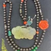 Traditional beaded necklace with jade pendant and flower.