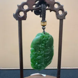 Carved jade pendant on display stand.