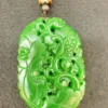 Intricately carved green jade pendant with cord.