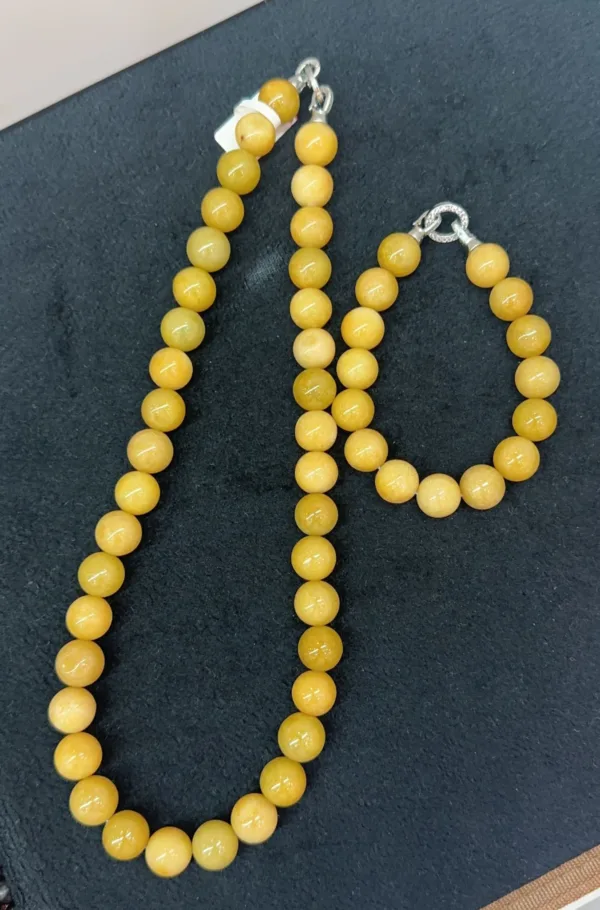 Yellow beaded necklace on dark background.