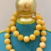 Golden beads necklace on mannequin display.