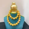 Gold and yellow beaded necklace on display.