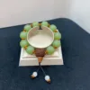 Jade bead bracelet with wooden accents on display.