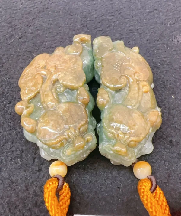 Carved jade pendant with dragon design and orange tassel.