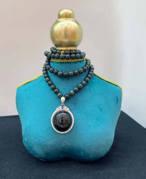 Elegant necklace on turquoise display stand.