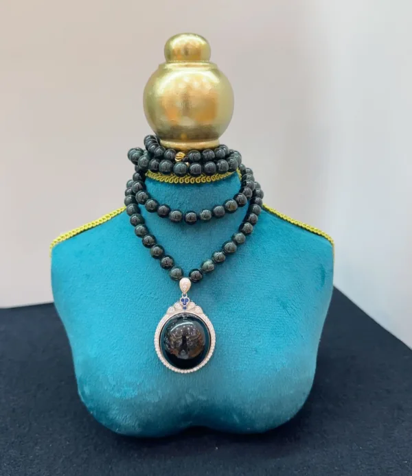 Elegant necklace on teal display stand.