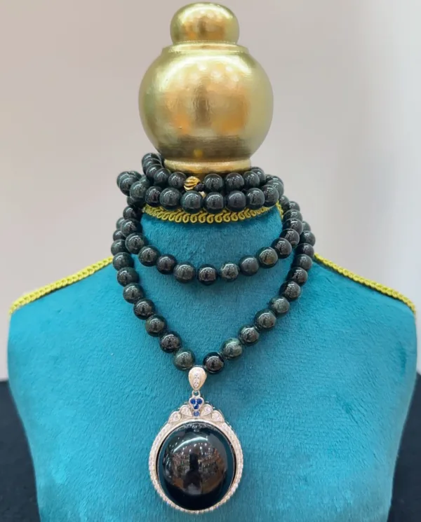 Elegant beaded necklace with pendant on mannequin.