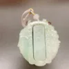 Carved jade pendant with Chinese inscription and cord