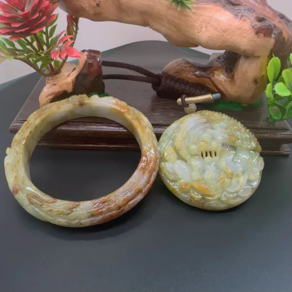 Carved jade bracelet and pendant on display.