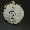 Carved jade pendant with intricate dragon design.