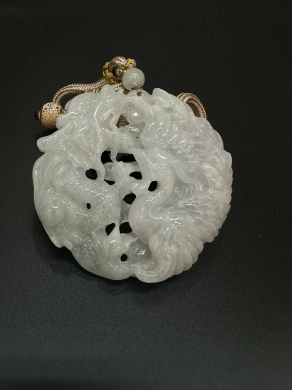 Carved jade pendant with intricate dragon design.