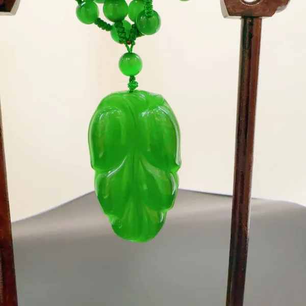 Green jade pendant in mask shape.