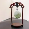 Carved jade disc on wooden stand