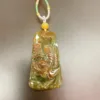 Carved jade pendant with decorative cord.