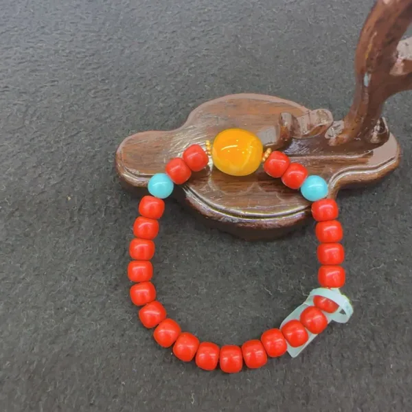 Colorful bead bracelet on wooden palette background.