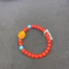 Colorful beaded bracelet on gray surface.