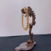 Wooden seahorse sculpture with bead ornament.