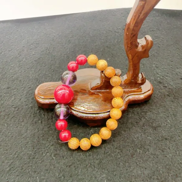 Wooden bracelet display stand with colorful beaded jewelry.