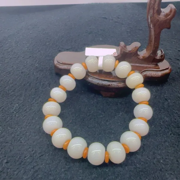 Beaded bracelet on wooden display stand.