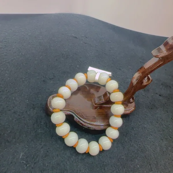 Beaded bracelet on wooden display stand.