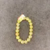 Yellow bead bracelet on gray background.