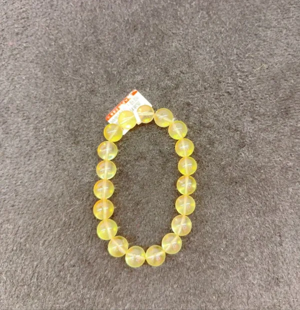 Yellow bead bracelet on gray background.