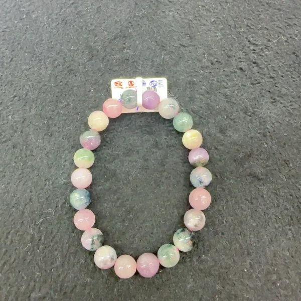 Multicolored beaded bracelet on textured background.