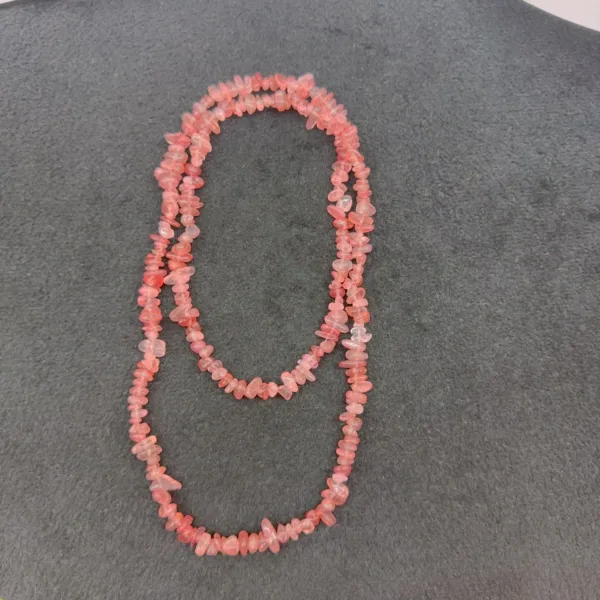 Coral beaded necklace on a dark background