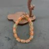 Colorful beaded bracelet on wooden stand