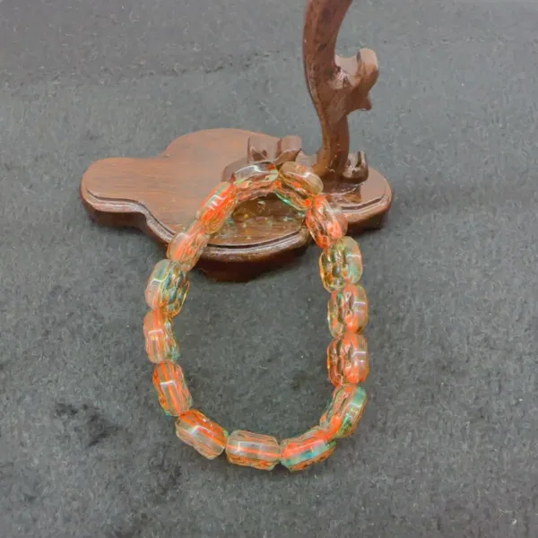 Colorful beaded bracelet on wooden stand