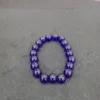 Blue bead bracelet on gray background.