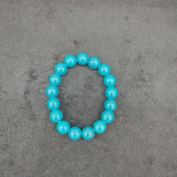 Blue beaded bracelet on gray background.