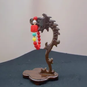 Carved wooden stand with colorful hanging beads.