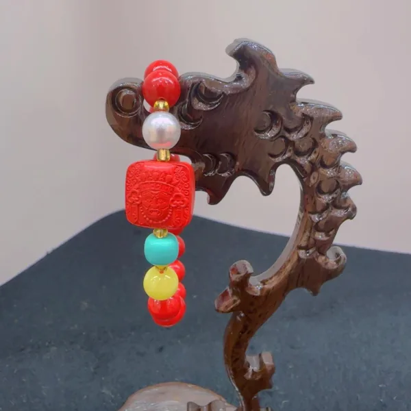 Colorful beaded ornament on wooden stand.