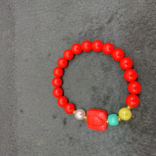 Colorful beaded bracelet on gray background.