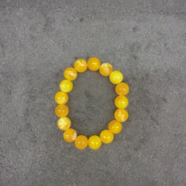 Yellow bead bracelet on gray background.