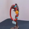 Colorful beaded bracelet on wooden display stand.