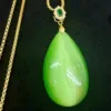 Gold necklace with green jade pendant.