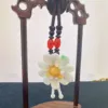 Jade flower ornament on wooden stand.