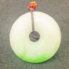 Jade pendant with red bead on top.